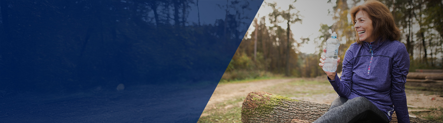 Happy middle-aged woman sitting outdoors